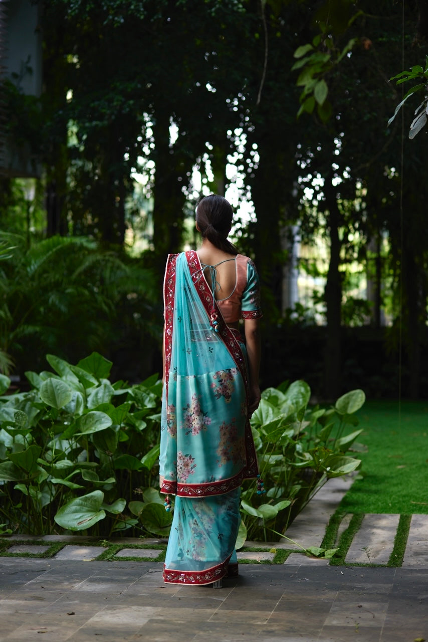 Mayura Kumar floral saree in aqua, peach and red, side view